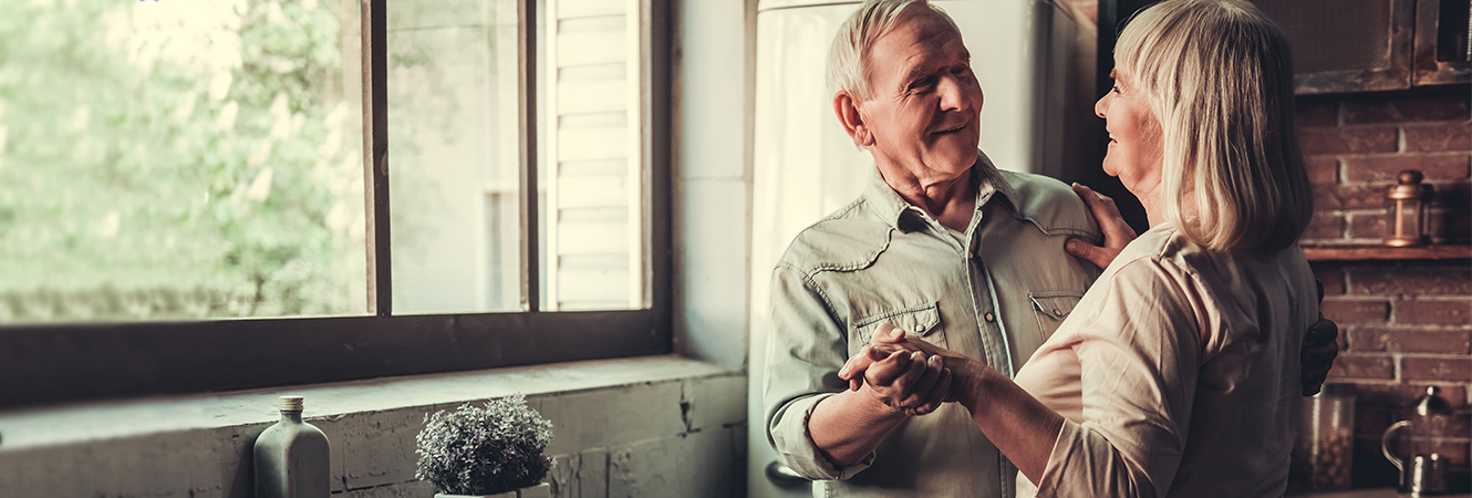 Senior couple dancing in kitchen