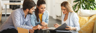 three people going over paperwork