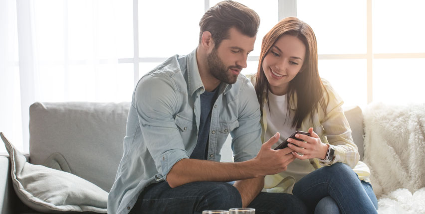 couple looking at something on smartphone 